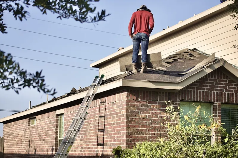 Professional roofer working on a residential roof in Willow Brook
